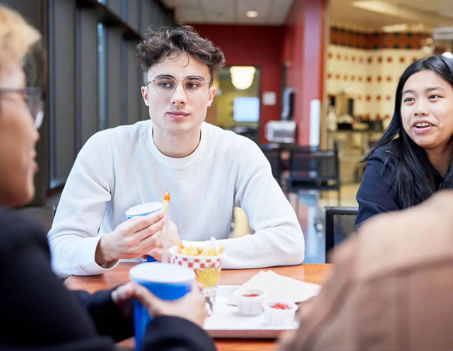 Students having lunch in the cafeteria.